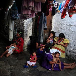 Indigenous Embera Kat?o sit at their home in Cali
