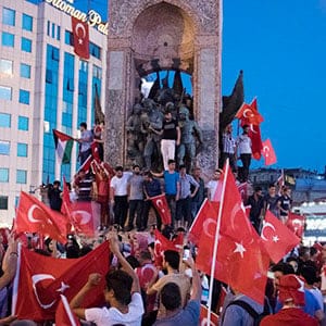 The day after a failed coup attempt in Turkey, supporters of President Recep Tayyip Erdogan and his AK Party gather at Taksim Square for a "Democracy festival", climbing onto the iconic monument of Mustafa Kemal Ataturk, modern Turkey's founder. The fallout from the failed coup has left Turkey more divided than ever between Islamists and secularists. (Photograph by Adnan Khan)