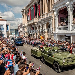 A carriage containing Fidel Castro's ashes drives down the street at Parque Cespedes in Santiago de Cuba, Cuba, Dec. 3, 2016. Bringing to an end nine days of national mourning, the ashes of Fidel Castro were buried on Sunday morning in a cemetery in this coastal city where, 63 years ago, he began his socialist revolution. (Tomas Munita/The New York Times/Redux)