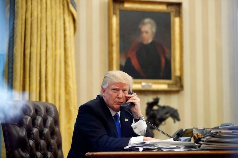 President Donald Trump speaks on the phone with Prime Minister of Australia Malcolm Turnbull in the Oval Office of the White House, Saturday, Jan. 28, 2017 in Washington. (AP Photo/Alex Brandon)