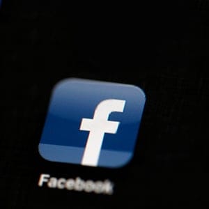 FILE - In this May 16, 2012 file photo, the Facebook logo is displayed on an iPad in Philadelphia. Facebook is adding more Snapchat-like features to its app. The company says it wants to let people's cameras "do the talking" as more people are posting photos and videos instead of blocks of text. With the update coming to users starting Tuesday, March 28, 2017, Facebook is adding a camera icon to the top left corner of its mobile app.. (AP Photo/Matt Rourke, File)