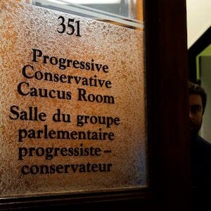 PC staff member leaves the room caucus room at Queen's Park in Toronto on Friday, January 26, 2018. Ontario Tories will huddle today to pick an interim leader who may lead them into the June provincial election, following Patrick Brown's resignation early yesterday morning in the face of sexual misconduct allegations, the party isn't even sure if it will hold a leadership race before the vote. THE CANADIAN PRESS/Nathan Denette