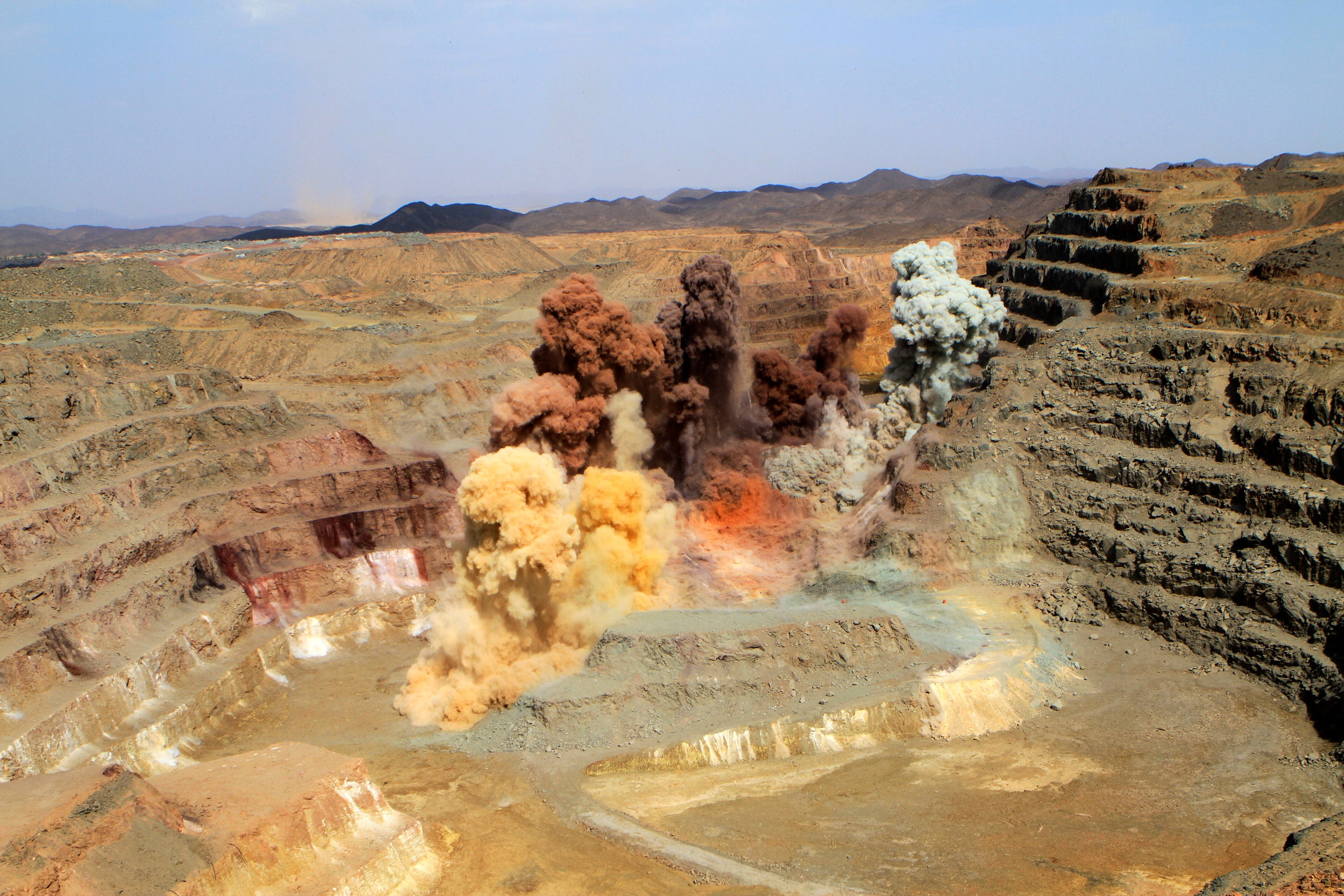 Smoke rises after a blast in a quarry at the Ariab mine