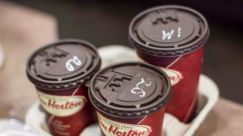Cups of coffee sit on a counter in a Tim Hortons outlet in Oakville, Ont., on September 16, 2013. Tim Hortons is pouring a new cup of joe starting today as it looks to attract coffee connoisseurs from some of its competitors. THE CANADIAN PRESS/Chris Young