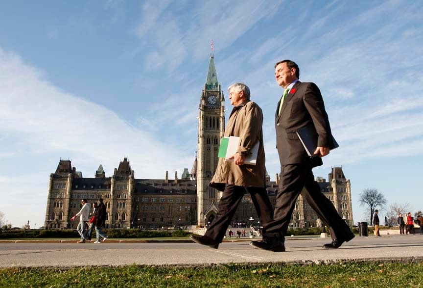 Canada's Finance Minister Jim Flaherty (R) walks to a news conference on the government's fiscal update with Transport Minister Lawrence Cannon, on Parliament Hill in Ottawa October 30, 2007. REUTERS/Chris Wattie (CANADA) - RTR1VHUO