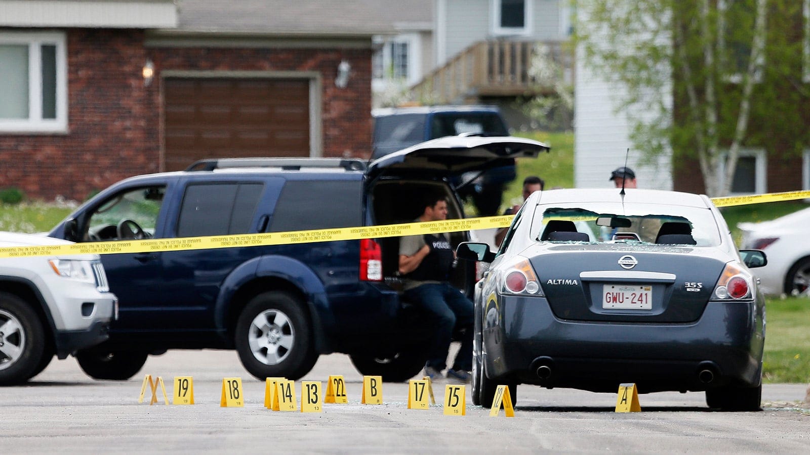 Evidence markers lie on a street at the scene of a shooting incident in the eastern city of Moncton, New Brunswick June 5, 2014. Canadian police mounted the massive hunt on Thursday for a 24-year-old man, Justin Bourque, armed with high-powered weapons who they suspect shot dead three police officers and wounded two more in Moncton. Christinne Muschi/Reuters