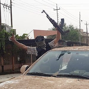Fighters of the Islamic State of Iraq and the Levant (ISIL) celebrate on vehicles taken from Iraqi security forces, at a street in city of Mosul