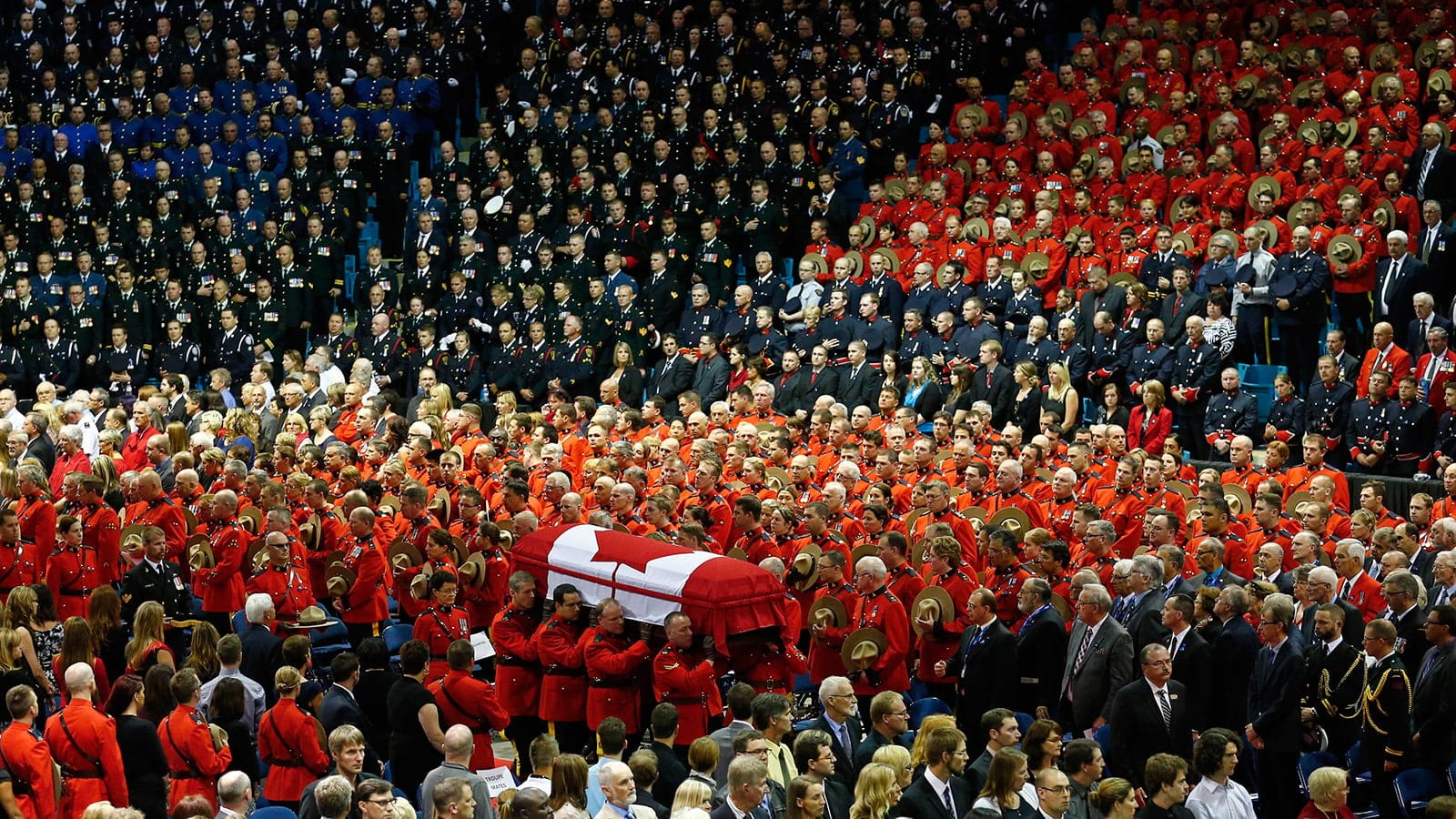 Pallbearers carry the casket of one of three Royal Canadian Mounted Police officers killed in a shooting in Moncton, N.B. (Mark Blinch/Reuters)