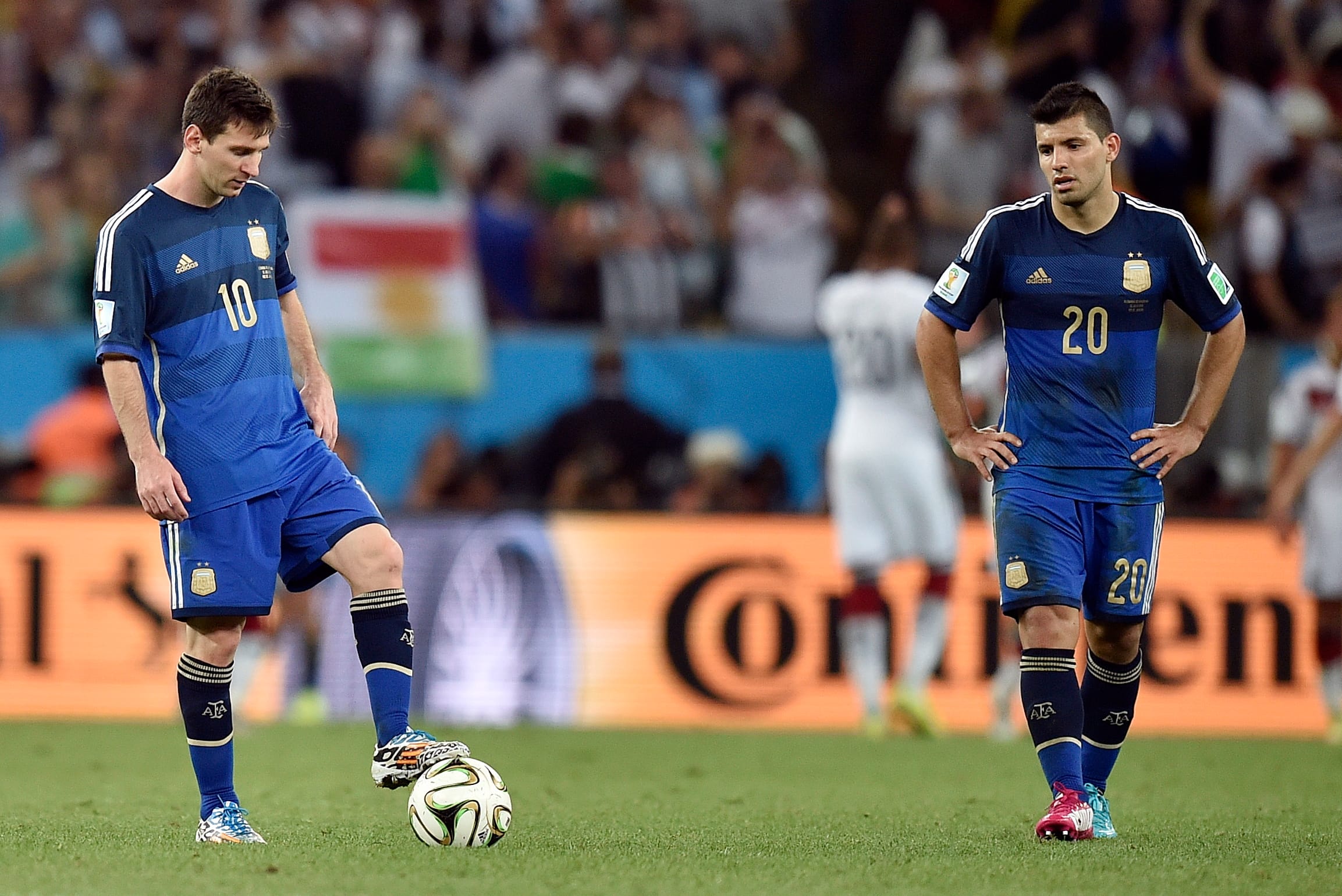 Argentina's Lionel Messi, left, and Sergio Aguero react after Germany's Mario Goetze scored the winning goal during the World Cup final soccer match between Germany and Argentina. (Martin Meissner/AP)