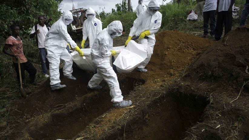 A WHO team buries the bodies of deceased patients whose families did not come near the Médecins Sans Frontières (MSF) Ebola Treatment Center in Kailahun, Sierra Leone.