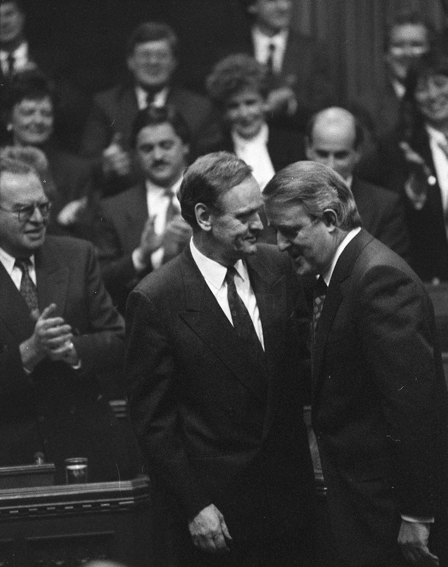 Prime Minister Brian Mulroney welcomes Official Opposition Leader Jean Chretien after he claimed his House of Commons seat Jan 15, 1991. (Chuck Mitchel, CP)