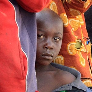 Congolese refugees queue for porridge at the Nyakabande refugee transit camp in Kisoro town