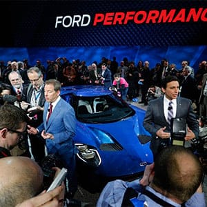 Ford CEO Mark Fields and Executive Chairman William Clay Ford, Jr. speak next to a Ford GT during the company's presentation on the first press preview day of the North American International Auto Show in Detroit