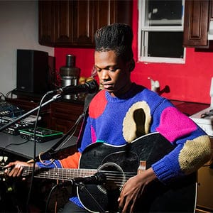 October 2014, Bushwick, NY. Shamir Bailey performs for a small circle of close friends in his home in Bushwick, adjacent to a musical venue/collective Silent Barn. (Dina Litovsky)