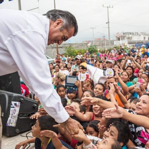 Jaime Heliodoro Rodriguez Calderon, also known as El Bronco, a candidate for governor for the state of Nuevo Leon, greets crowd members during a rally in the La Alianza Real neighborhood of Escobedo, Mexico, May 21, 2015. Calderon is the first independent candidate to run for the seat in Nuevo Leon, a state that runs along the Texas border that is a major industrial hub and also a battlefield among drug gangs. (RODRIGO CRUZ/The New York Times/Redux)