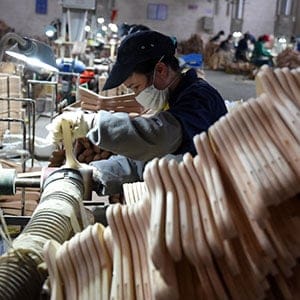 Workers process clothes hangers at a factory in Lipu County, southwest China's Guangxi Zhuang Autonomous Region, Jan. 6, 2015. With 126 factories manufacturing clothes hangers, the yearly output of the trade in Lipu reached 6.5 billion RMB yuan (about 1.06 billion U.S. dollars). (Lu Bo'an/Xinhua/Eyevine/Redux)