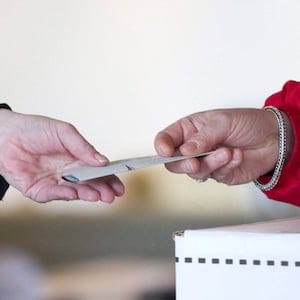 An election official hands back to a voter her marked ballot to place in the ballot box so she can cast her vote for the federal election at a polling station on Toronto's Ward Island on Monday May 2, 2011. Elections Canada scrambled to staff dozens of polling stations across Canada on May 2 when the people it hired called in sick, slept late, took unauthorized meal breaks — or quit in a huff over working conditions. THE CANADIAN PRESS/Chris Young