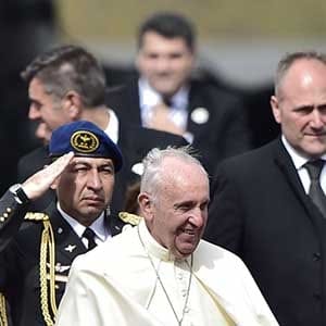 Pope Francis (C) is welcomed by Ecuador's President Rafael Correa (R) as he arrives at the Mariscal Sucre international airport in Quito on July 5, 2015. Pope Francis arrived in Quito Sunday to begin his first South American trip in two years, for an eight-day tour of Ecuador, Bolivia and Paraguay highlighting the plight of the poor on his home continent. AFP PHOTO / RODRIGO BUENDIA (Photo credit should read RODRIGO BUENDIA/AFP/Getty Images)