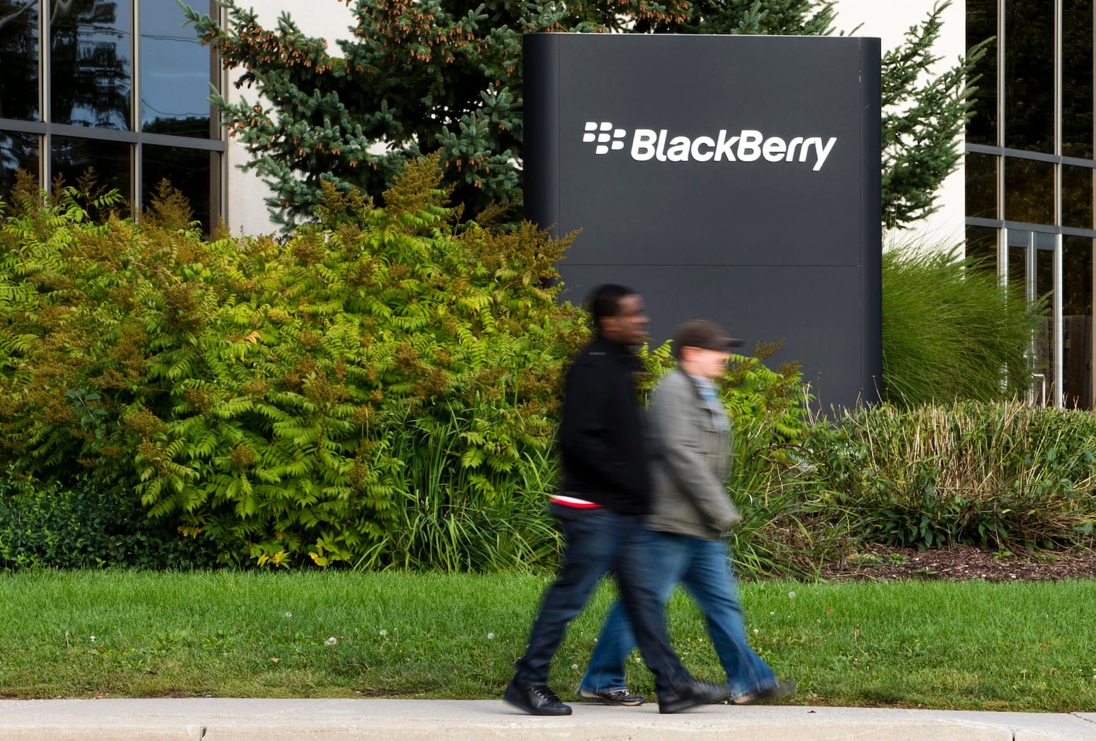 People walk on the sidewalk at the Blackberry campus in Waterloo, September 23, 2013. REUTERS/Mark Blinch (CANADA - Tags: BUSINESS EMPLOYMENT) - RTX13WW1