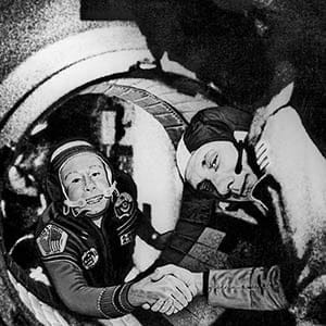Commander of the Soviet crew of Soyuz, Alexei Leonov (L) and commander of the American crew of Apollo, Thomas Stafford (R), shake hands 17 July 1975 in the space, somewhere over Western Germany, after the Apollo-Soyuz docking manoeuvres. (AFP/Getty Images)