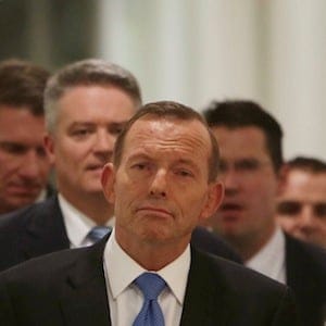 Australian Prime Minister Tony Abbott, center, leaves the Australian Liberal Party meeting in which he lost the party leadership at Parliament House in Canberra, Monday, Sept. 14, 2015. Australia's beleaguered prime minister Abbott was ousted from power in an internal party ballot on Monday as the ruling conservative party attempts to win back a disenchanted public by replacing the nation's polarizing, gaffe-prone leader with his more moderate rival. Abbott lost a leadership ballot by members of his party, who voted 54 to 44 to replace him with former Liberal Party leader and Communications Minister Malcolm Turnbull, Liberal Party whip Scott Buchholz told reporters. (AP Photo/Andrew Taylor)