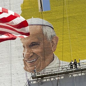 The U.S. flag flies as painters work on a mural of Pope Francis on the side of a building in midtown Manhattan in New York August 28, 2015. Pope Francis is scheduled to visit Washington D.C., New York and Philadelphia September 22-27. (Brendan McDermid/Reuters)