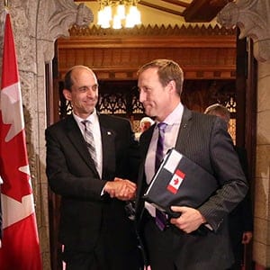 Public Safety Minister Steven Blaney (left) shakes hands with Justice Minister Peter MacKay as they leave the Senate Chambers after Royal Assent of several bills on Thursday, June 18, 2015. (Fred Chartrand/CP)