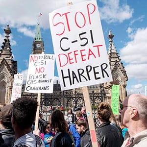 People protest on Parliament Hill during a day of action against Bill C-51, the government's proposed anti-terrorism legislation, Saturday, April 18, 2015 in Ottawa. (Justin Tang/CP)