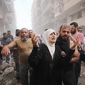ALEPPO, SYRIA - SEPTEMBER 20 : Syrian people carry wounded ones to hospital after Assad Regime Forces stage an airstrike to opposition controlled Muvasalat district of Aleppo, Syria on September 20, 2015. (Mamun Ebu Omer/Anadolu Agency/Getty Images)