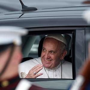 Pope Francis waves from his car, a Fiat 500, after arriving at Andrews Air Force Base, Md., Tuesday, Sept. 22, 2015. The Pope is spending three days in Washington before heading to New York and Philadelphia. This is the Pope's first visit to the United States. (Susan Walsh/AP)