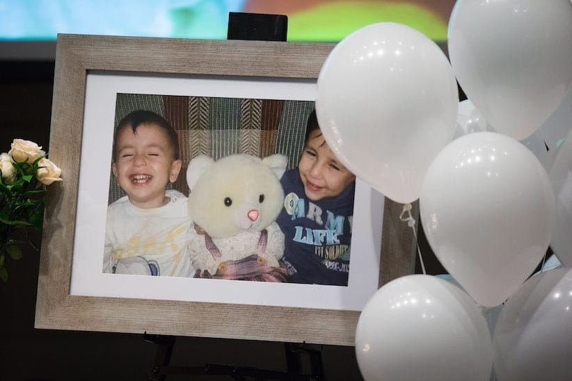 A photograph of brothers Alan and Ghalib Kurdi is displayed during a memorial service for them and their mother in Vancouver, B.C., on Saturday. The brothers' aunt lives in the Vancouver area. (Darryl Dyck, The Canadian Press)