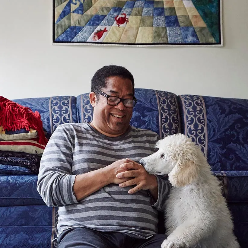 Andre Alexis in his home. (Photograph by Jaime Hogge)