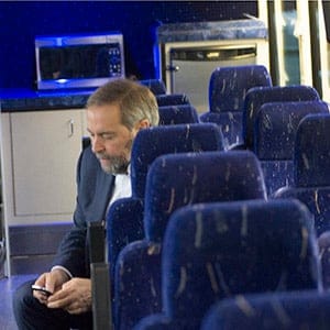 NDP leader Tom Mulcair checks his smartphone on the bus while visiting the Treaty 3 Ojibway reserve in Wednesday, October 7, 2015 in Whitefish Bay, Ontario. (Ryan Remiorz/CP)