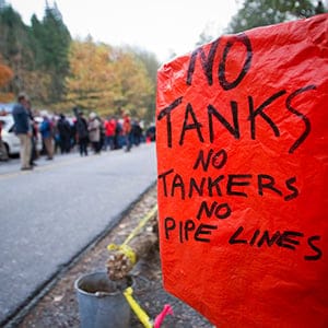 An anti-oil tanker sign is pictured near a demonstration against the proposed Kinder Morgan pipeline on Burnaby Mountain in Burnaby, British Columbia November 17, 2014. Kinder Morgan Energy Partners LP said on November 14, 2014 it would resume preliminary work on its Trans Mountain pipeline after a British Columbia court granted an injunction against protesters blocking work crews in the Vancouver suburb of Burnaby. (Ben Nelms/Reuters)