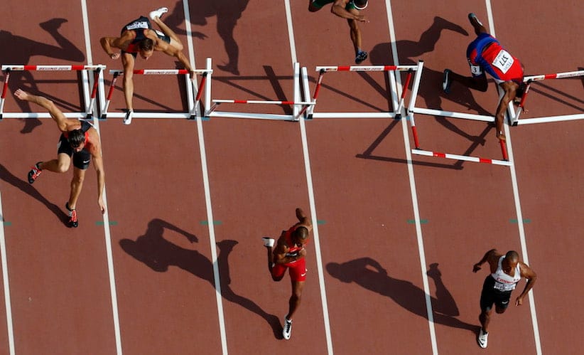 Yordani Garcia of Cuba (top R) crashes into a hurdle during his 110 hurdles heat of the men's decathlon at the 15th IAAF Championships at the National Stadium in Beijing, China August 29, 2015. REUTERS/Fabrizio Bensch - RTX1Q4BZ