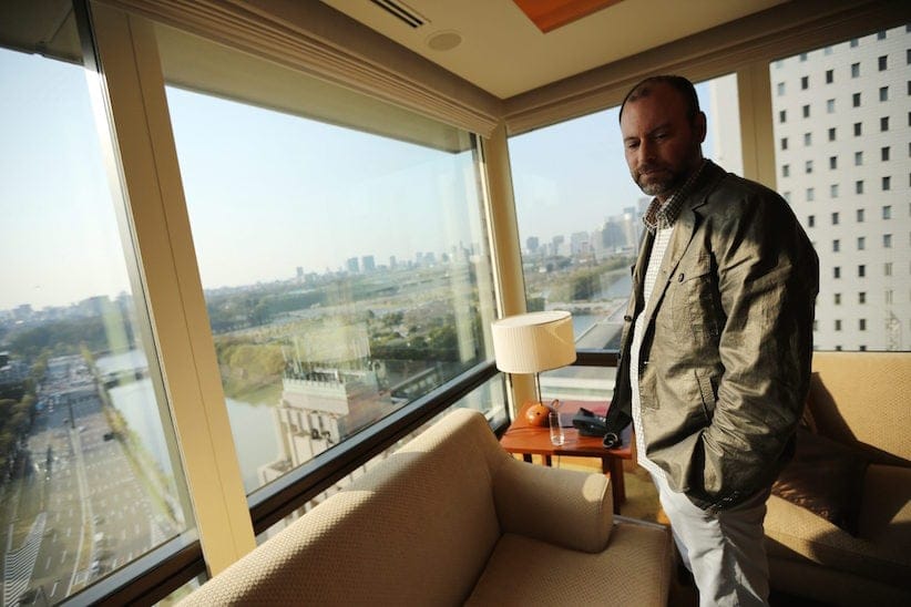 Noel Biderman, chief executive of Avid Life Media Inc., which operates AshleyMadison.com., poses by a hotel room window overlooking the Imperial Palace grounds during a photo session in Tokyo. Biderman is stepping down in the wake of the massive breach of the company’s computer systems and outing of millions of its members, Avid Life Media announced, Friday, Aug. 28, 2015. (AP Photo/Eugene Hoshiko, File)