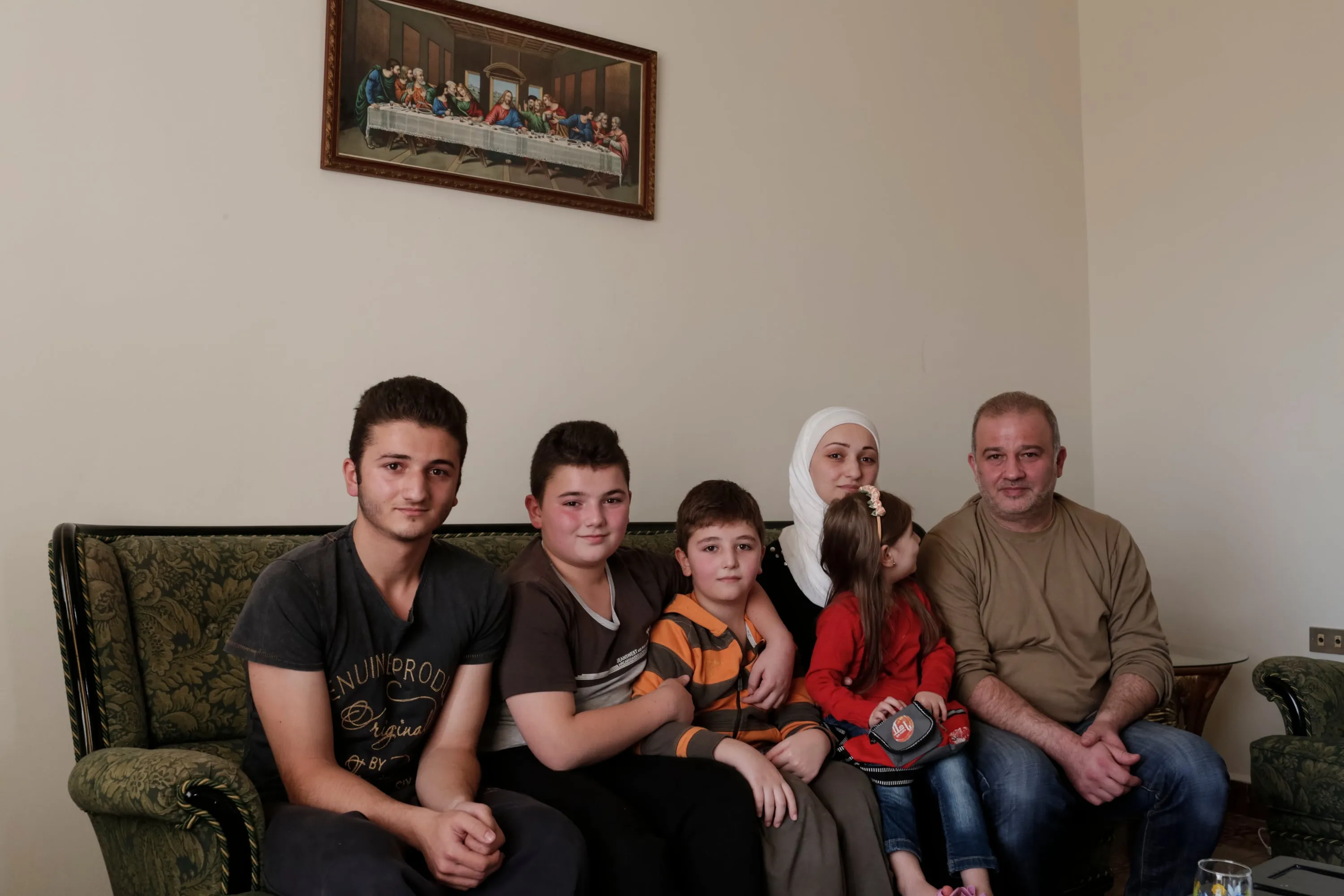 Mohamed Alftih, 45, from Aleppo in Syria sits with his family - Randa, 35; Sham, 3; Ghaith 10; Omar, 13 and Karim, 16 - in the home of friend with whom they are staying near the town of Byblos in Lebanon, on November 28, 2015. (Photograph by Sam Tarling)