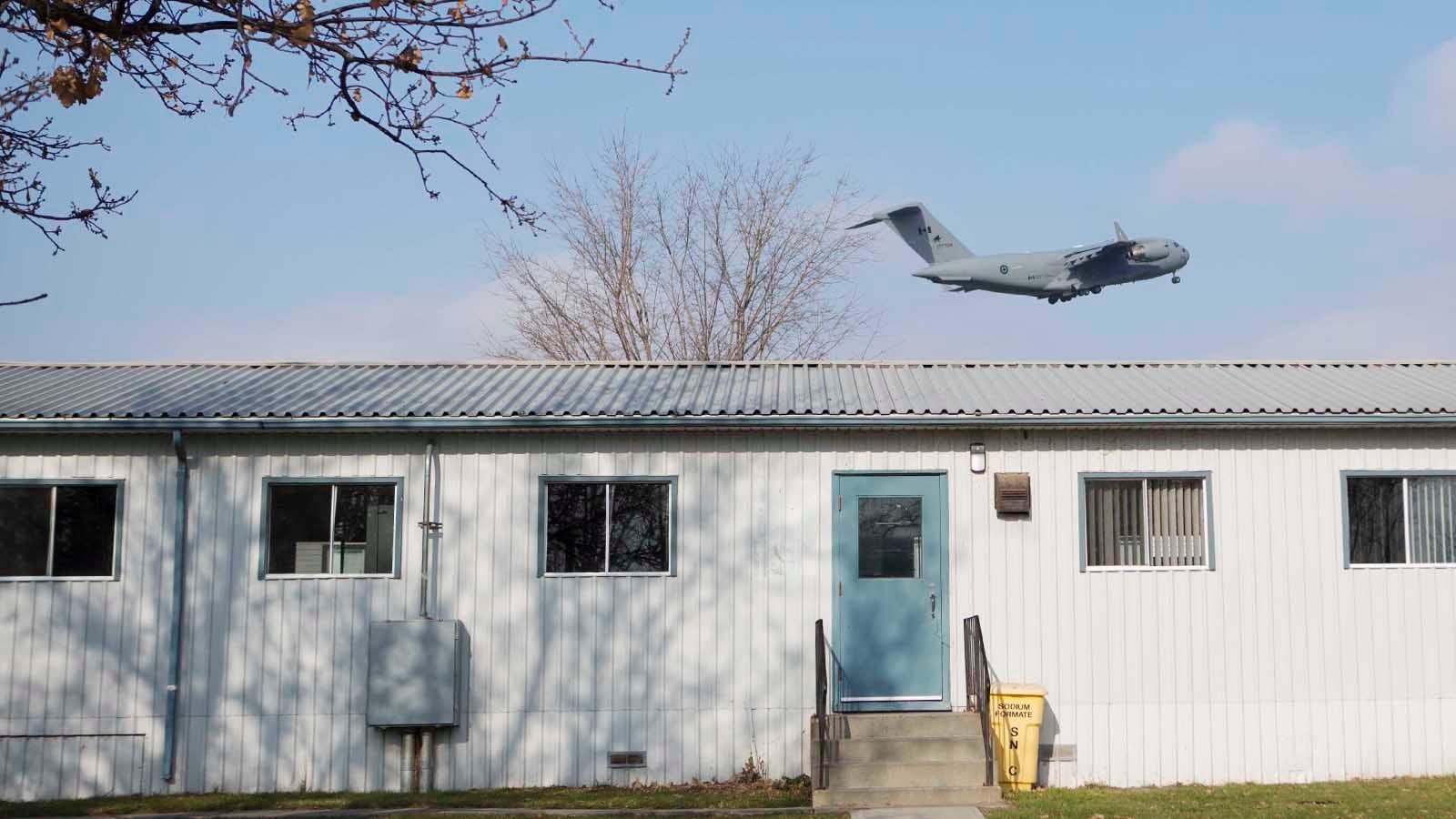 November 25, 2015 - TRENTON, ON: A cc - 177 Globemaster III flies over the barracks that will potentially be used for refugees at the Trenton Cadet Training Centre on CFB Trenton. (Photograph by Della Rollins)(Photograph by Della Rollins)