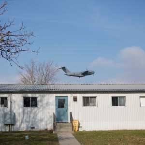 November 25, 2015 - TRENTON, ON: A cc - 177 Globemaster III flies over the barracks that will potentially be used for refugees at the Trenton Cadet Training Centre on CFB Trenton. (Photograph by Della Rollins)(Photograph by Della Rollins)