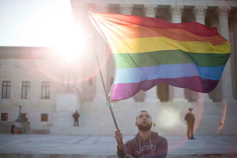 WASHINGTON, DC - APRIL 28: Same-sex marriage supporter Vin Testa, of Washington, DC, waves a rainbow pride flag near the Supreme Court, April 28, 2015 in Washington, DC. On Tuesday the Supreme Court will hear arguments concerning whether same-sex marriage is a constitutional right, with decisions expected in June. (Drew Angerer/Getty Images)