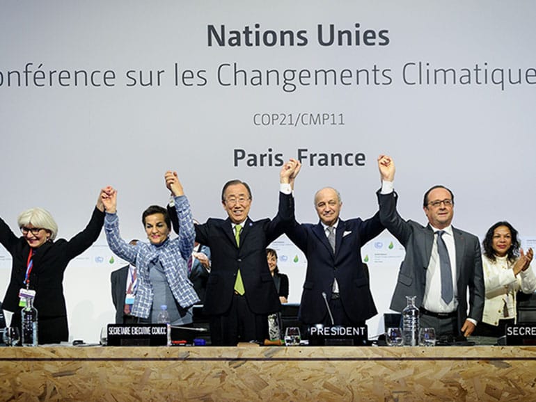 PARIS, FRANCE - DECEMBER 12: Executive Secretary of the United Nations Framework Convention on Climate Change (UNFCCC) Christiana Figueres (L 2), Secretary General of the United Nations Ban Ki Moon (C), Foreign Affairs Minister and President-designate of COP21 Laurent Fabius (R 2), and France's President Francois Hollande (R) raise hands together after adoption of a historic global warming pact at the COP21 Climate Conference in Le Bourget, north of Paris, on December 12, 2015. Arnaud BOUISSOU/Anadolu Agency/Getty Images