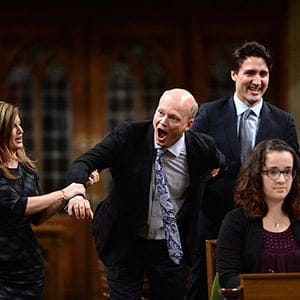Newly-elected Speaker of the House Geoff Regan, centre, jokingly resists as he's escorted to the speaker's chair by Conservative interim leader Rona Ambrose, left, and Prime Minister Justin Trudeau in the House of Commons on Parliament Hill in Ottawa on Thursday, Dec. 3, 2015. (Sean Kilpatrick/CP)