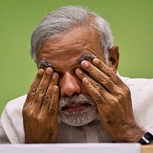 FILE- In this April 6, 2015 file photo, India’s Prime Minister Narendra Modi rubs his eye as he attends a conference by the environment ministry in New Delhi, India. Modi is facing a revolt within his Hindu nationalist party by senior leaders questioning his leadership style after the recent debacle in state elections. (Saurabh Das/AP)