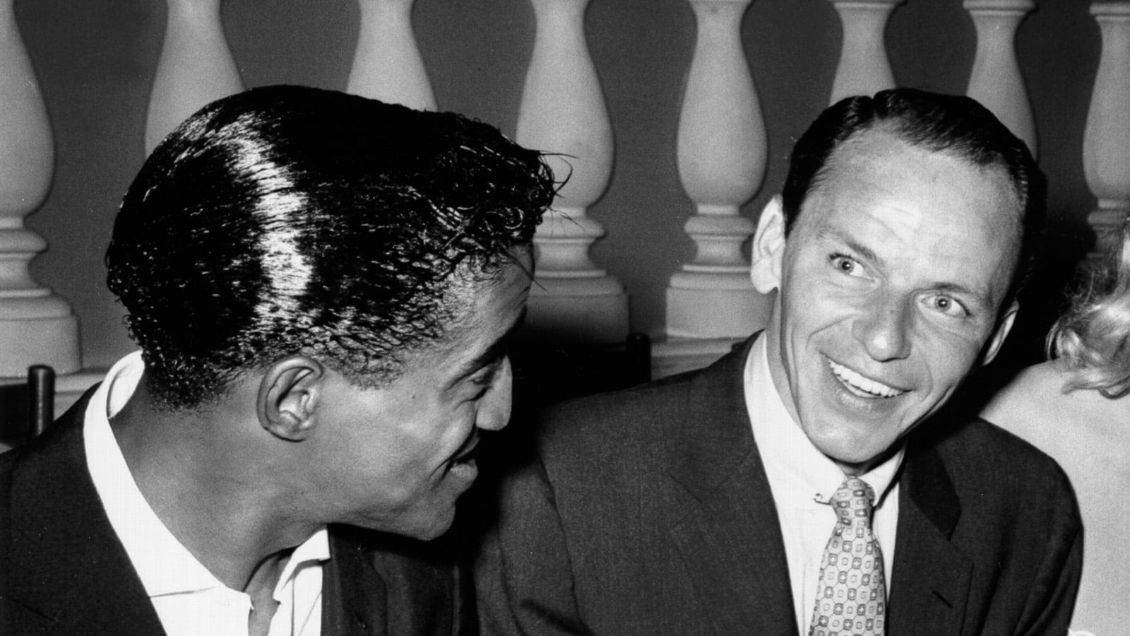 Singer and member of the Rat Pack Sammy Davis Jr., Frank Sinatra, actress Anita Ekberg and restauranteur Mike Romanoff dine at Romanoff's Restaurant on August 1, 1955 in Los Angeles, California. (Earl Leaf/Michael Ochs Archives/Getty Images)