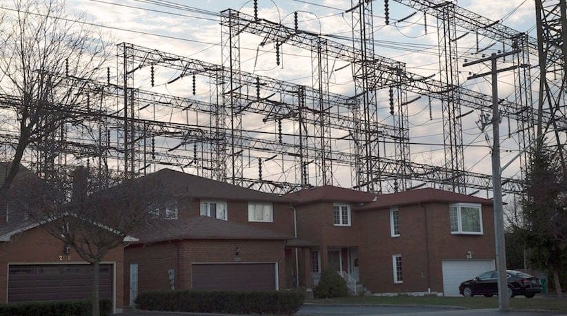 Homes are shown next to hydro lines in Mississauga, Ont., on Wednesday, December 2, 2015. Ontario's auditor general says electricity customers paid 37 billion dollars for the Liberal government's decisions to ignore its own planning process for new power projects. THE CANADIAN PRESS/Nathan Denette