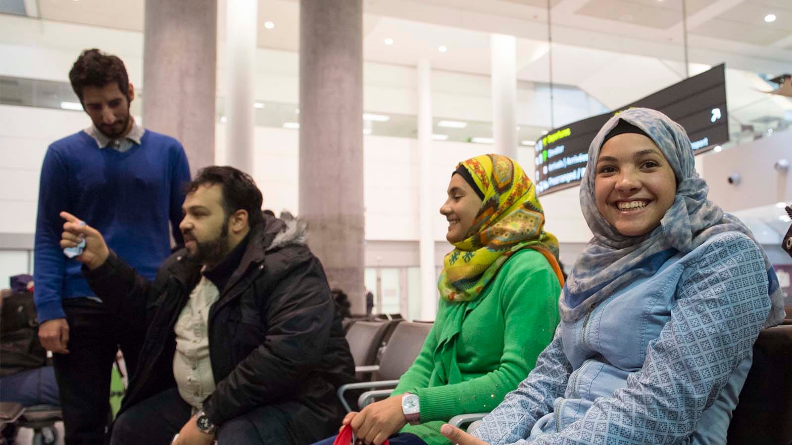 Syrian refugee siblings Rama, right, Riem, and Raniem take a rest with translators Bassam Alolayan, left, and Mohammad Samkari, at the Toronto Pearson International Airport after arriving from Frankfurt, Germany on Thursday, Dec. 10, 2015. Photo by Hannah Yoon