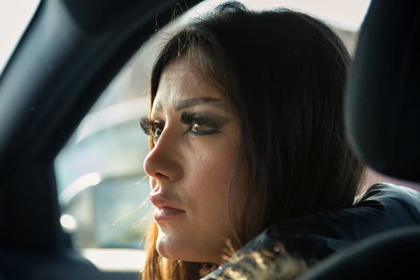 Stopped at a red light, Rasha looks to her fiancé Arturo from the passenger seat of his car. Rasha says she loves to go for long drives, often without any destination in mind.