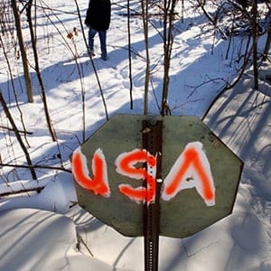 This makeshift sign marks the border between Quebec and New York State in an isolated area just south of the hamlet of Powers Court, Quebec. (Ken Faught/Toronto Star/Getty Images)