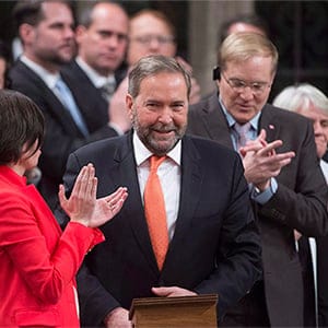 NDP Leader Tom Mulcair is applauded by NDP members of parliament after responding to the government's speech from the throne in the House of Commons, on Parliament Hill, in Ottawa, on Monday, Dec. 7, 2015. Adrian Wyld/CP