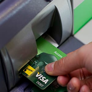 A customer uses an ATM (automated teller machine) at a Toronto-Dominion (TD) Bank branch in downtown Vancouver, British Columbia, Canada, on Thursday, May 28, 2015. Toronto-Dominion Bank said fiscal second-quarter profit fell 6.5 percent as the lender took a C$228 million ($183 million) restructuring charge. Photographer: Ben Nelms/Bloomberg via Getty Images